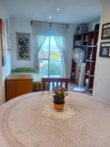 a bedroom with a table with a potted plant on it at vistas del valle in Villa Carlos Paz