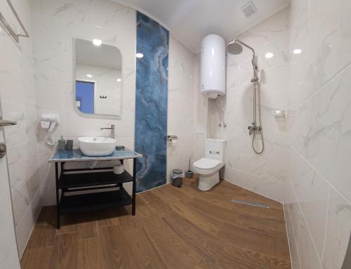 a bathroom with a sink and a toilet at Къща за гости ЕСТЕТ ESTET Guest house in Oreshak