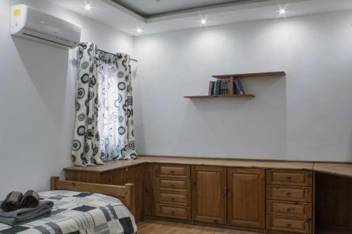 a bedroom with a bed and a dresser at Brand New 3 BDR Apartment in a Quaint Village in Fgura