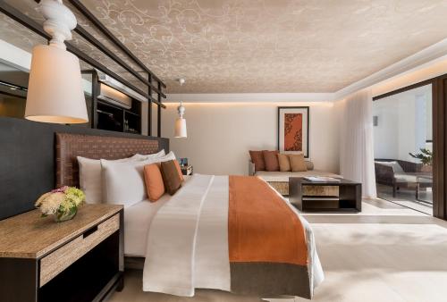 a bedroom with a large bed and a living room at The District Boracay in Boracay