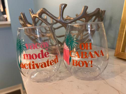 two empty wine glasses sitting on top of a counter at Beach More Getaway in Vero Beach