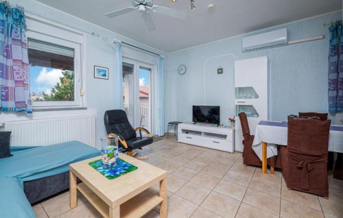 a living room with a couch and a table at Beautiful Apartment In Barbariga in Barbariga