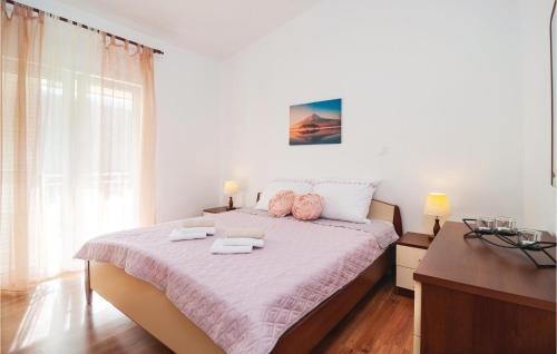 a bedroom with a bed with two towels on it at 2 Bedroom Amazing Apartment In Slime in Slime