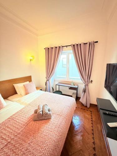 Ένα ή περισσότερα κρεβάτια σε δωμάτιο στο Happy Sintra Inn