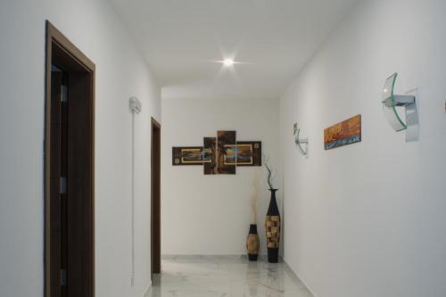 a white room with a cross on the wall at Brand New 3 BDR Apartment in a Quaint Village in Fgura