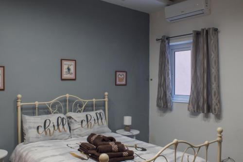 a bedroom with a bed with a teddy bear on it at Brand New 3 BDR Apartment in a Quaint Village in Fgura
