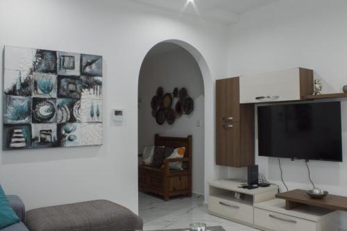 a living room with a couch and a tv at Brand New 3 BDR Apartment in a Quaint Village in Fgura