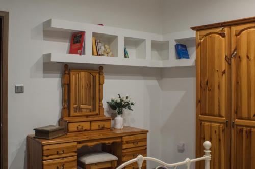 a room with a wooden cabinet and a dresser at Brand New 3 BDR Apartment in a Quaint Village in Fgura