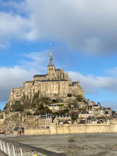 a large building on top of a mountain at Le Clos de la Barre- Chambres d'hôtes de charme en Normandie-BASLY-Proche plage débarquement in Basly