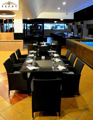 a dining room with a long table and chairs at Sepoy Grande Mysore in Mysore