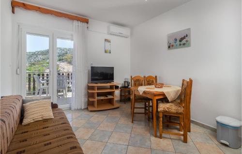 a living room with a couch and a table and a television at 4 Bedroom Nice Apartment In Sveti Juraj in Sveti Juraj