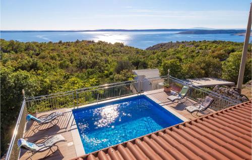 a swimming pool sitting on top of a house at Beautiful Home In Jablanac With Wifi in Jablanac