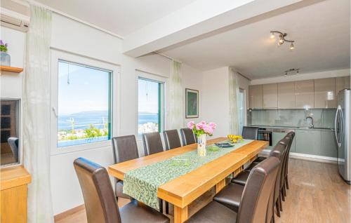 a kitchen and dining room with a table and chairs at Amazing Home In Makarska in Makarska