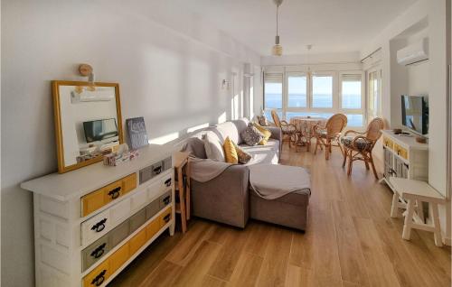 a living room with a couch and a television at Lovely Apartment In Algarrobo-Costa in Algarrobo-Costa