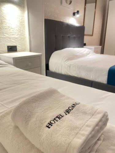 a white towel on a bed in a hotel room at Hotel Arganda in Arganda del Rey