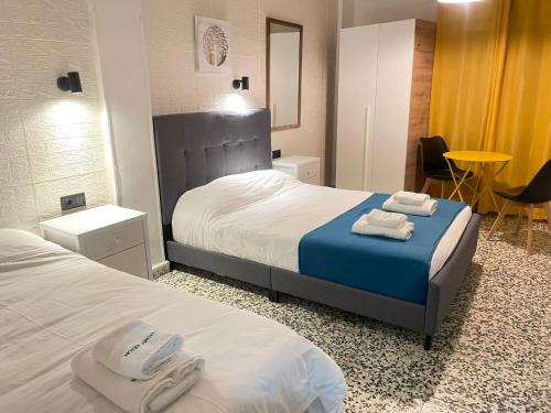 a hotel room with two beds with towels on them at Hotel Arganda in Arganda del Rey