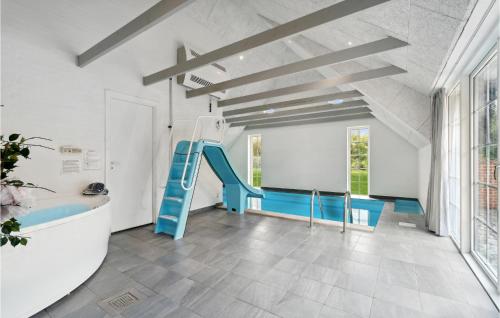 a play room with a blue slide in a building at Beautiful Home In Ulfborg With Sauna in Øby