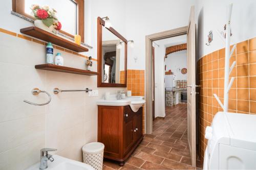 a bathroom with a sink and a mirror at Casa Murru & Sale in Irgoli