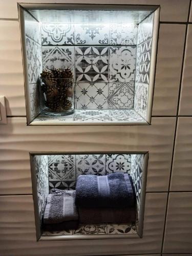 a shelf in a bathroom with a mirror at GOURA House in Metsovo