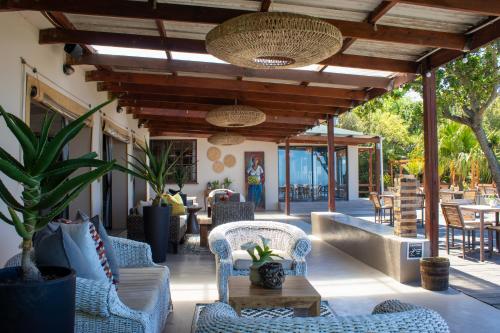 an outdoor patio with chairs and tables and a table at The Ocean Dome - Misty Mountain Reserve in Thornham