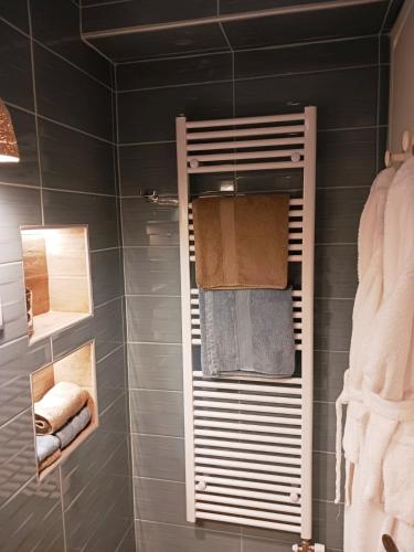 a bathroom with a towel rack with towels at GOURA House in Metsovo