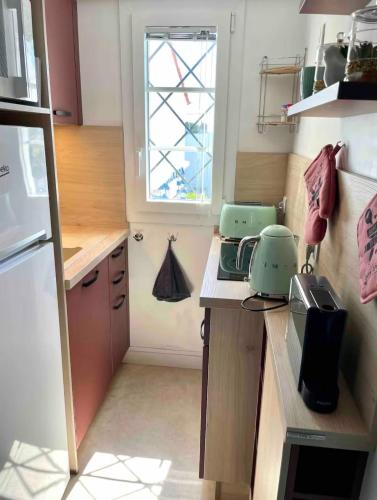 une petite cuisine avec un comptoir et une fenêtre dans l'établissement Duplex vue Mer Royan, à Royan