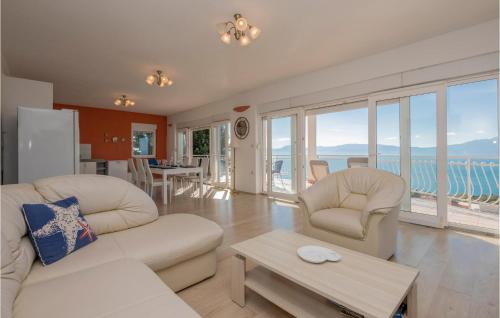 a living room with two white couches and a table at Three-Bedroom Apartment In Podaca in Podaca