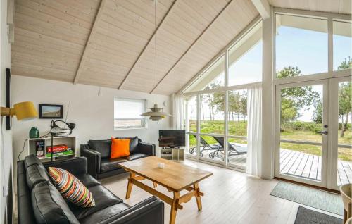 a living room with a couch and a table at Three-Bedroom Holiday Home In Knebel in Knebel