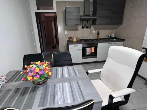 a kitchen with a table with a vase of flowers on it at Rozvadov Vimali in Rozvadov