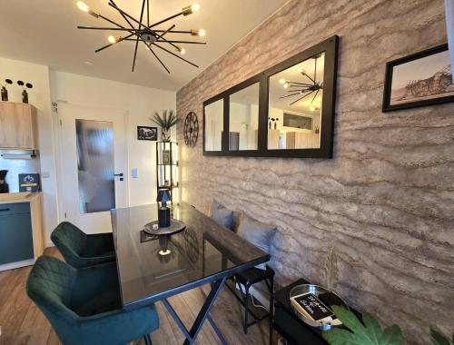 a living room with a glass table and a mirror at Fifty Shades of Green P18 Apartment in Dresden