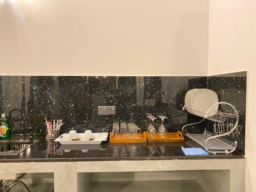 a kitchen counter with a sink and a appliance at Eco Vibe Villa Hiriketiya in Dickwella