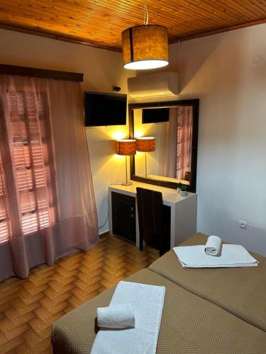 a bedroom with a bed and a desk with a desk at Christodoulos Villa in Agios Georgios