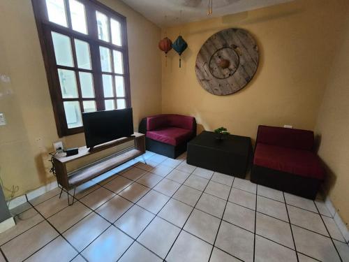 a living room with two couches and a tv at Casa Damian in Puerto Vallarta
