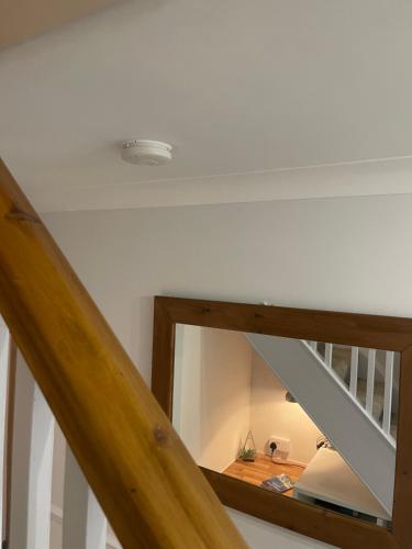 a room with a staircase with a mirror on the ceiling at Escape to the Beach in Poole