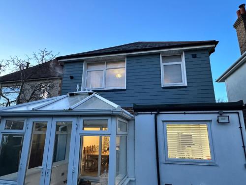a house with aconservatory with a window at Escape to the Beach in Poole