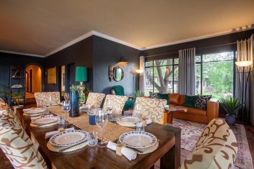 a living room with a wooden table and chairs at Parsons River Camp in Balule Game Reserve