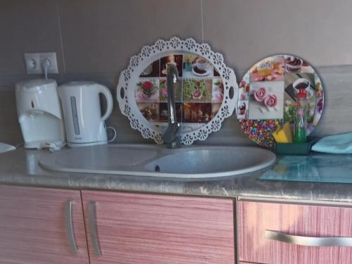 a kitchen counter with a sink and a mirror at Casa Juanlu in Málaga