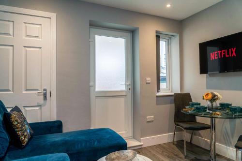 a living room with a blue couch and a table at Central Oxford Apartments Terrace in Oxford