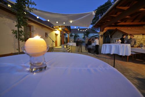 a candle sitting on top of a table at a party at Zsirai Guest House in Mád