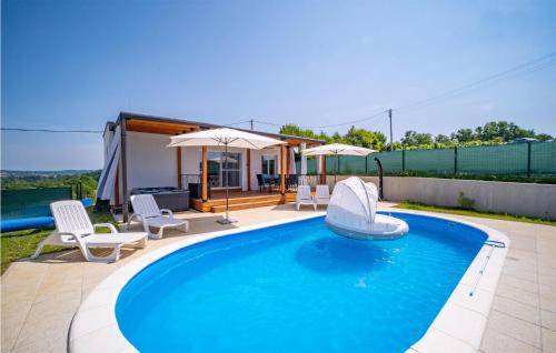 a swimming pool with a slide in front of a house at Stunning Home In Cerovacki Galovici in Galović-Selo