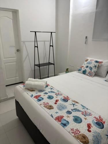 a bedroom with a bed with a blanket on it at Casa Turbay in Cartagena de Indias