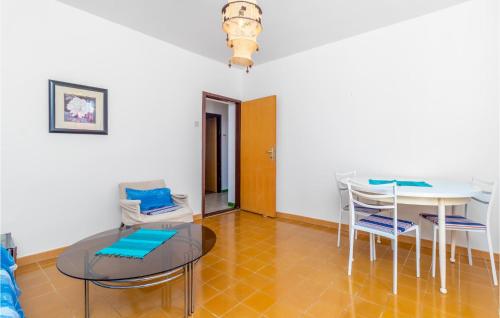 a dining room with a glass table and chairs at 3 Bedroom Nice Apartment In Klenovica in Klenovica