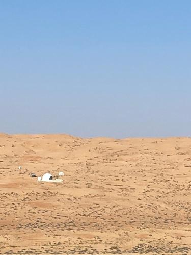 a tent in the sand in the desert at Azalea private luxury tent in Al Raka
