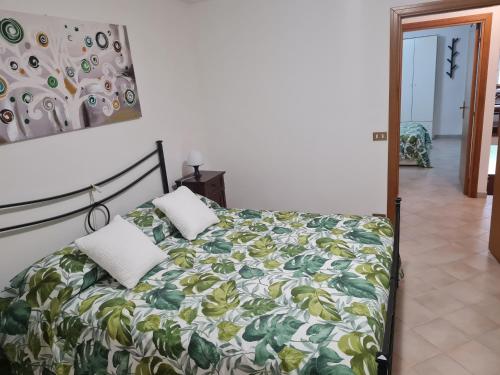 a bed with two pillows on it in a bedroom at Casa vacanze Castello in Frontone