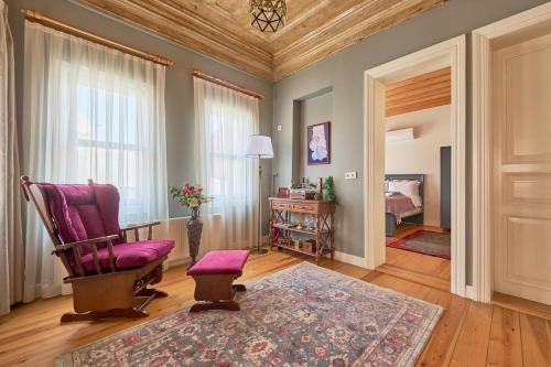 a living room with a rocking chair and a bedroom at Nostalgic & Comfortable Historical Home! in Istanbul
