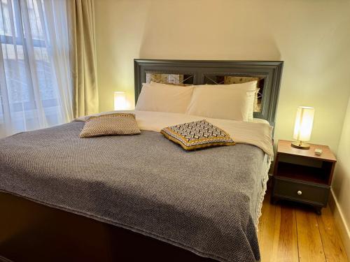 a bedroom with a large bed with two pillows on it at Nostalgic & Comfortable Historical Home! in Istanbul