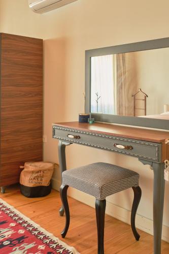 a dressing table with a mirror and a stool at Nostalgic & Comfortable Historical Home! in Istanbul