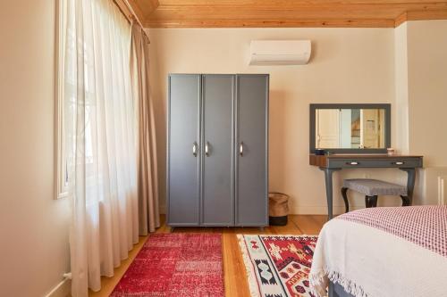 a bedroom with a bed and a dresser and a desk at Nostalgic & Comfortable Historical Home! in Istanbul