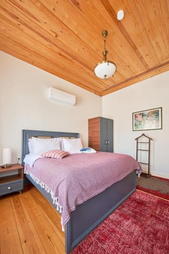a bedroom with a large bed and a wooden ceiling at Nostalgic & Comfortable Historical Home! in Istanbul