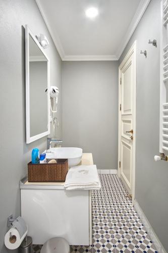 a bathroom with a sink and a mirror at Nostalgic & Comfortable Historical Home! in Istanbul